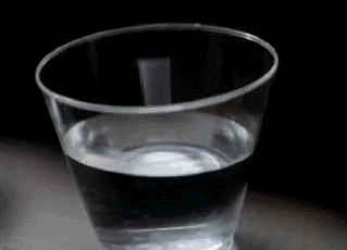 A glass of water tremors forebodingly